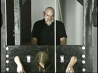 Old guy pounds young brunette with small tits jailed in stocks