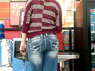 Beautiful teen in jeans candid at self checkout