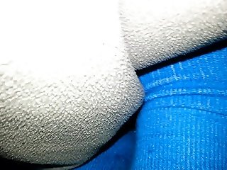 Massaging his cock with soft blue socks