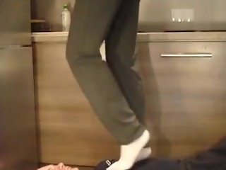 Amateur trampling in sport socks and standing on head and throat